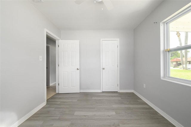 4824 Shoshone St, Orlando, FL 32819 - unfurnished bedroom featuring light wood finished floors, baseboards, and ceiling fan
