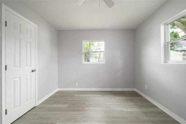 4824 Shoshone St, Orlando, FL 32819 - empty room with light wood-type flooring, ceiling fan, and baseboards
