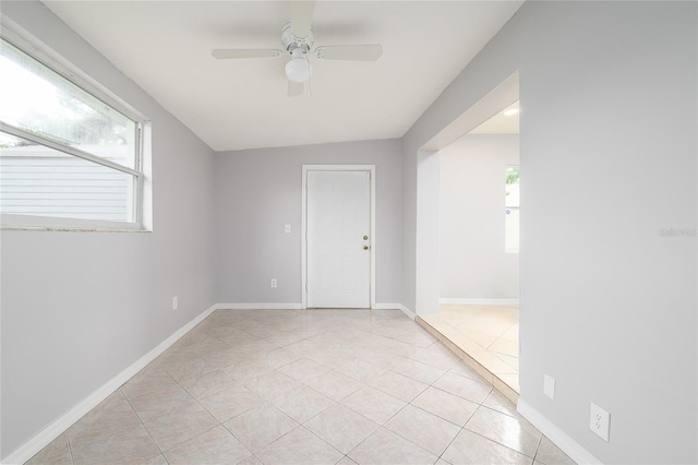 4824 Shoshone St, Orlando, FL 32819 - empty room featuring healthy amount of natural light, light tile patterned floors, and a ceiling fan