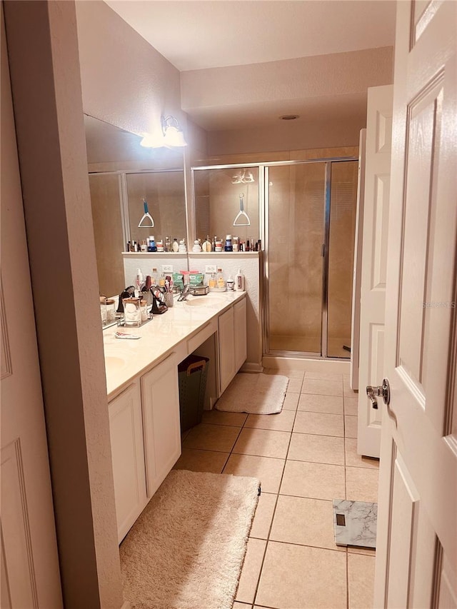 6450 Alcalde Ct Unit 106, Orlando, FL 32835 - full bathroom with double vanity, a shower stall, and tile patterned flooring