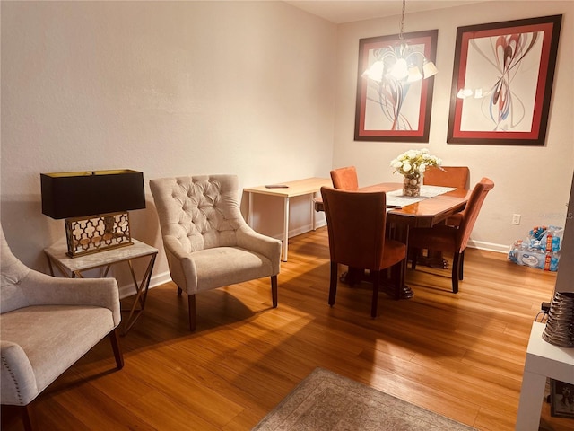6450 Alcalde Ct Unit 106, Orlando, FL 32835 - dining space featuring wood finished floors and a chandelier