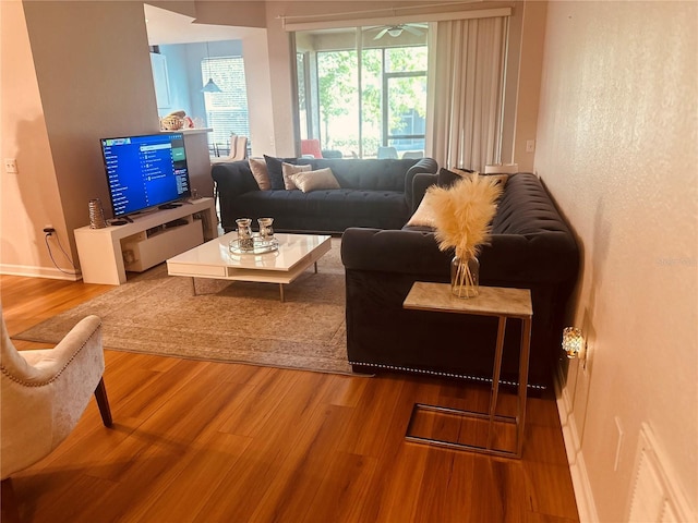 6450 Alcalde Ct Unit 106, Orlando, FL 32835 - living area featuring wood finished floors and a ceiling fan