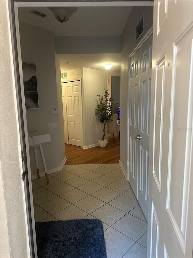 6450 Alcalde Ct Unit 106, Orlando, FL 32835 - hall with light tile patterned floors and baseboards