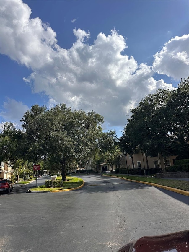 6450 Alcalde Ct Unit 106, Orlando, FL 32835 - view of asphalt road with curbs and traffic signs