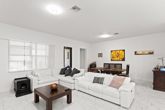 4445 SW 173rd Ave, Miramar, FL 33029 - living room featuring light marble finish floors, a wood stove, and baseboards