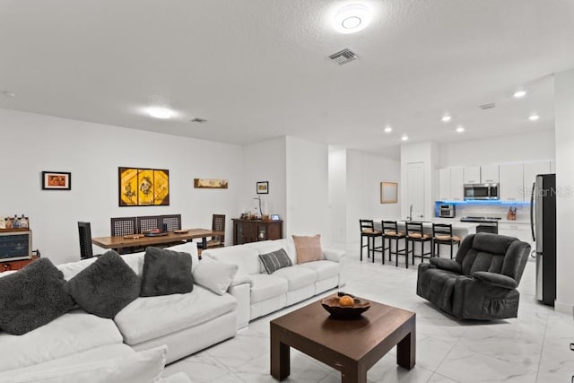 4445 SW 173rd Ave, Miramar, FL 33029 - living room featuring light marble finish flooring and recessed lighting