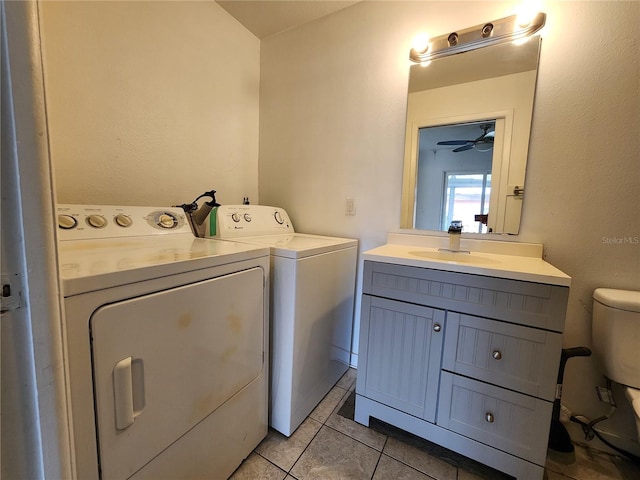 washroom with washer and dryer, light tile patterned floors, and a ceiling fan