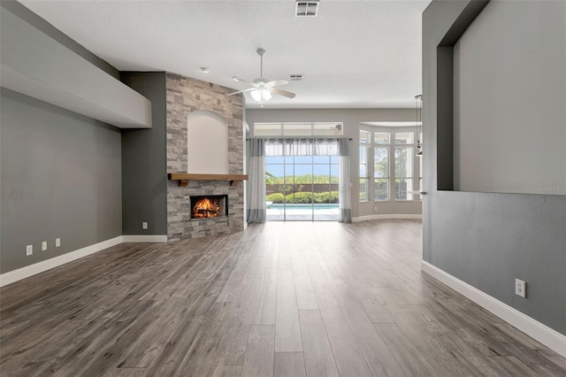 12411 Scarlett Sage Ct, Winter Garden, FL 34787 - unfurnished living room with ceiling fan, wood finished floors, a fireplace, and baseboards