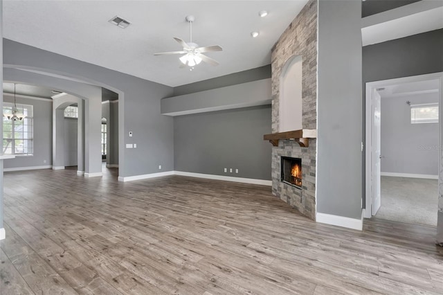 12411 Scarlett Sage Ct, Winter Garden, FL 34787 - unfurnished living room featuring a ceiling fan, wood finished floors, a fireplace, and baseboards