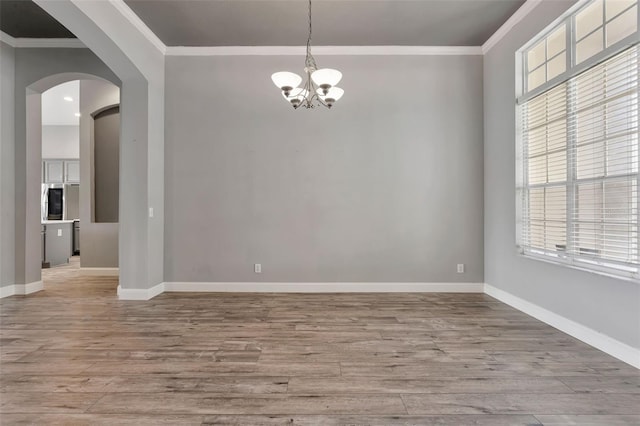 12411 Scarlett Sage Ct, Winter Garden, FL 34787 - empty room with ornamental molding, plenty of natural light, wood finished floors, a chandelier, and baseboards