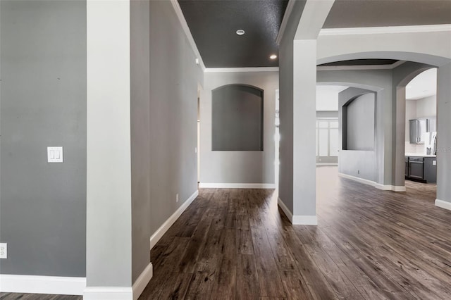 12411 Scarlett Sage Ct, Winter Garden, FL 34787 - corridor with ornamental molding, dark wood-type flooring, baseboards, and arched walkways