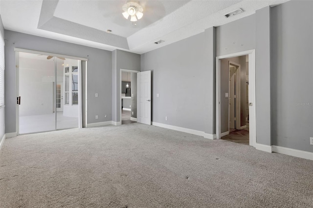 12411 Scarlett Sage Ct, Winter Garden, FL 34787 - unfurnished bedroom with carpet flooring, baseboards, and a raised ceiling