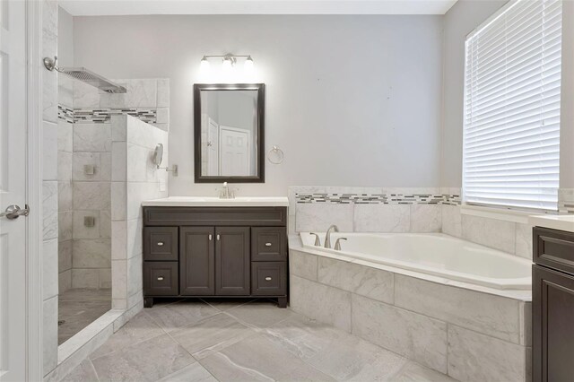 12411 Scarlett Sage Ct, Winter Garden, FL 34787 - bathroom featuring vanity, a bath, tiled shower, and healthy amount of natural light