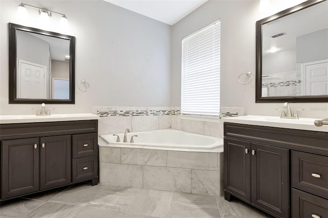 12411 Scarlett Sage Ct, Winter Garden, FL 34787 - full bathroom with a bath, two vanities, and marble finish flooring