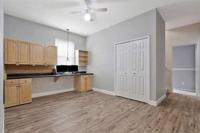 12411 Scarlett Sage Ct, Winter Garden, FL 34787 - kitchen with light brown cabinetry, dark countertops, and light wood-type flooring