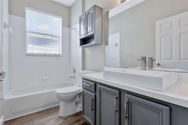 12411 Scarlett Sage Ct, Winter Garden, FL 34787 - full bathroom with wood finished floors, vanity, toilet, and bathtub / shower combination