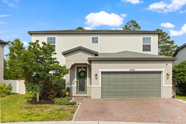 5458 Carrara Ct, Saint Cloud, FL 34771 - traditional-style house featuring stucco siding, decorative driveway, and a garage