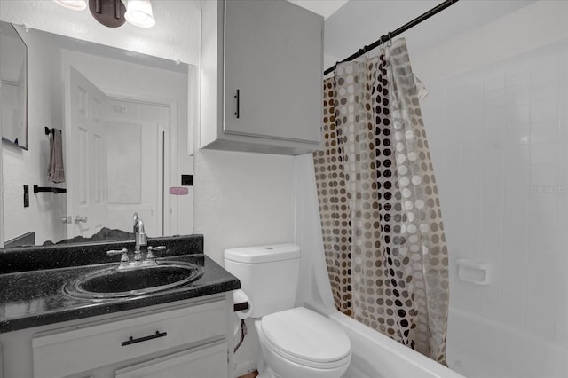 bathroom featuring toilet, shower / tub combo, and vanity