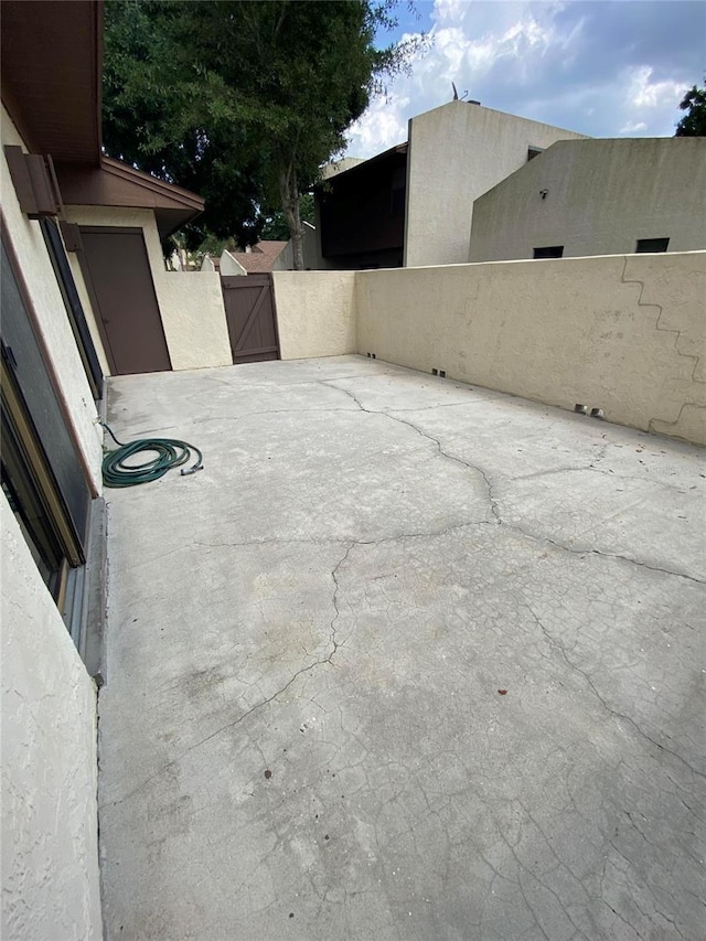 view of patio featuring a gate