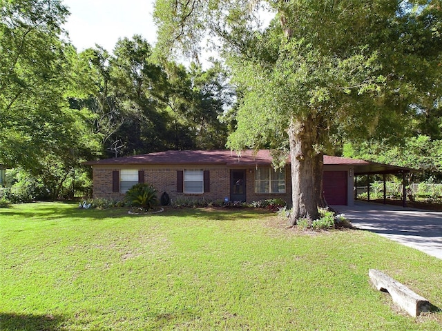 view of front of home featuring concrete driveway, a front lawn, an attached garage, an attached carport, and brick siding