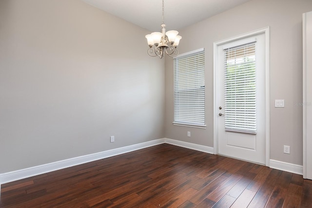 625 Pavia Loop, Lake Mary, FL 32746 - spare room with a chandelier, dark wood-style flooring, and baseboards