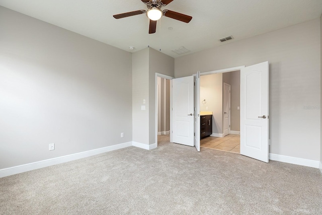 625 Pavia Loop, Lake Mary, FL 32746 - unfurnished bedroom with light colored carpet, baseboards, ensuite bathroom, and ceiling fan