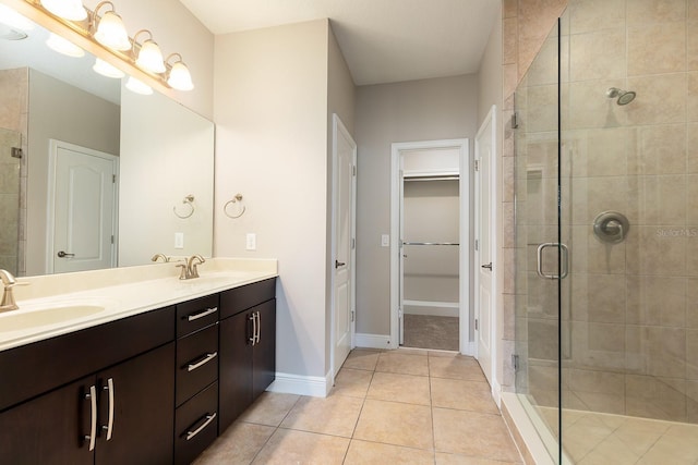 625 Pavia Loop, Lake Mary, FL 32746 - full bathroom with a shower stall, tile patterned floors, double vanity, a spacious closet, and baseboards