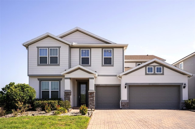 2539 Auburn Ridge Dr, Apopka, FL 32712 - craftsman inspired home featuring decorative driveway, stone siding, an attached garage, and stucco siding