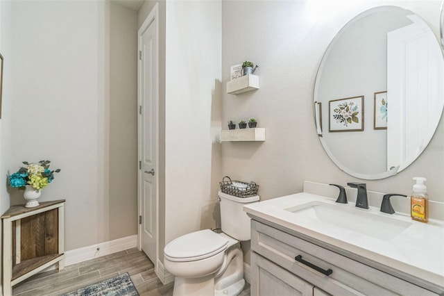 2539 Auburn Ridge Dr, Apopka, FL 32712 - bathroom featuring wood finished floors, vanity, toilet, and baseboards