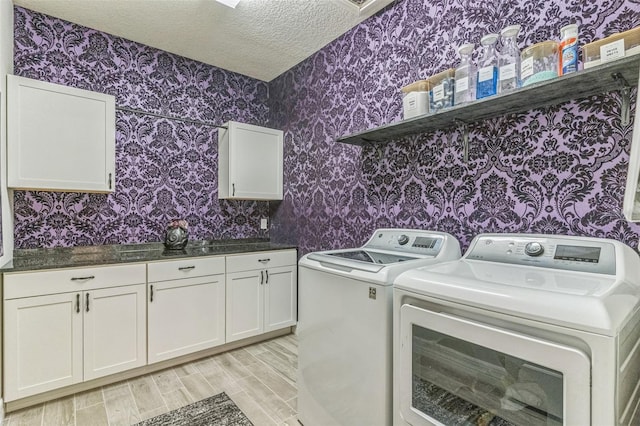2539 Auburn Ridge Dr, Apopka, FL 32712 - laundry area featuring separate washer and dryer, wallpapered walls, cabinet space, a textured ceiling, and light wood finished floors