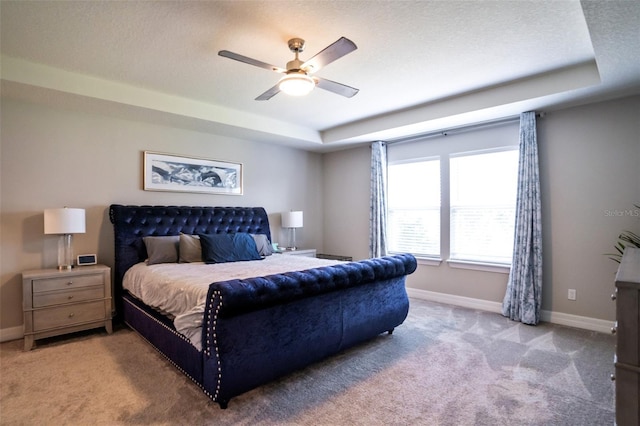 2539 Auburn Ridge Dr, Apopka, FL 32712 - carpeted bedroom featuring a tray ceiling, baseboards, and a ceiling fan
