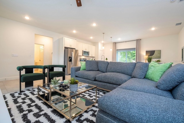 living area featuring recessed lighting, light tile patterned floors, baseboards, and ceiling fan