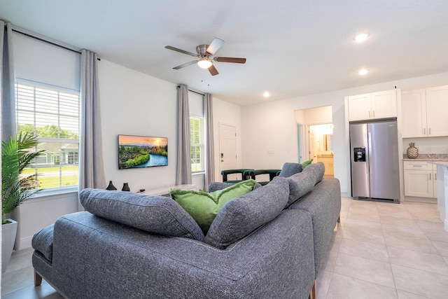 living area with plenty of natural light, a ceiling fan, recessed lighting, and light tile patterned floors