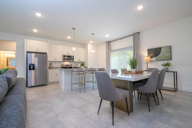 dining space featuring recessed lighting and baseboards