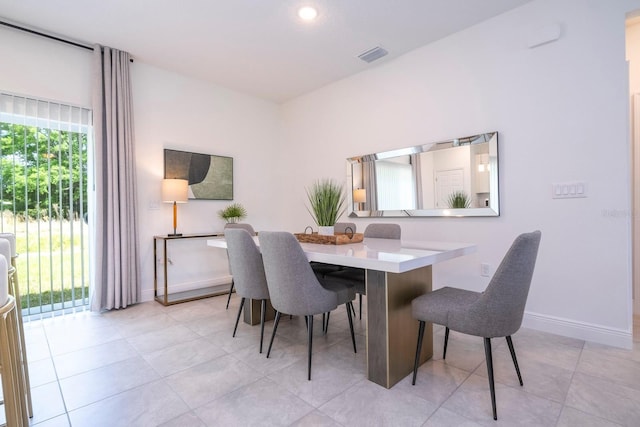 dining room featuring baseboards, light tile patterned flooring, and recessed lighting