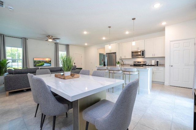 dining space with recessed lighting, a ceiling fan, and light tile patterned flooring