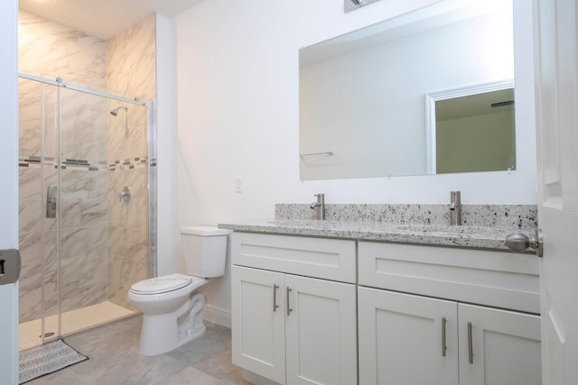 full bath with toilet, a shower stall, and double vanity