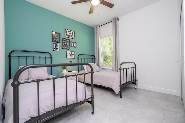 bedroom with baseboards and a ceiling fan