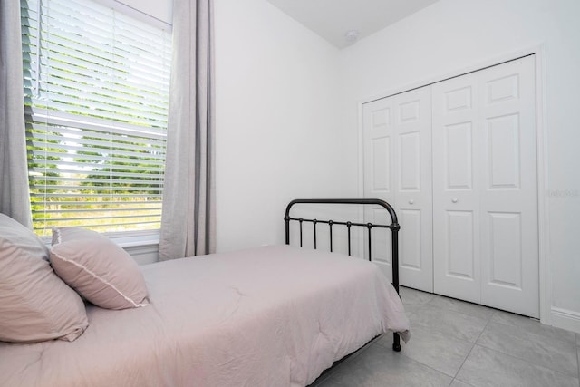 bedroom featuring light tile patterned floors and a closet
