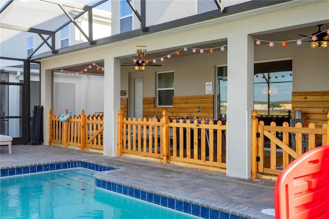 2836 Simile St, Kissimmee, FL 34746 - swimming pool with ceiling fan, glass enclosure, and a patio area