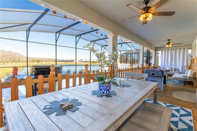 2836 Simile St, Kissimmee, FL 34746 - wooden deck featuring outdoor dining space, a ceiling fan, a water view, outdoor lounge area, and glass enclosure