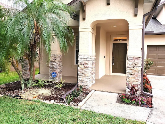 property entrance with stucco siding and stone siding