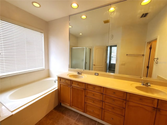 bathroom featuring a shower stall, double vanity, a garden tub, recessed lighting, and tile patterned floors