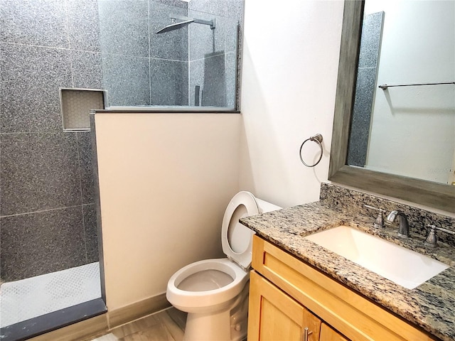full bathroom with a walk in shower, toilet, and vanity