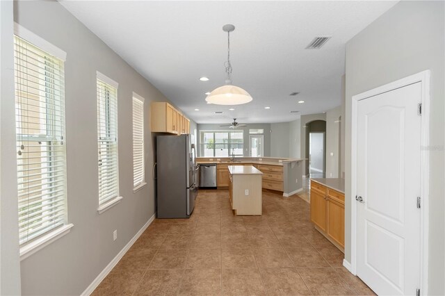 6728 Duncaster St, Windermere, FL 34786 - kitchen featuring appliances with stainless steel finishes, a ceiling fan, light countertops, light tile patterned floors, and arched walkways