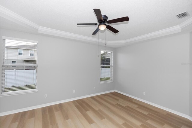 6728 Duncaster St, Windermere, FL 34786 - spare room with crown molding, light wood-style floors, a raised ceiling, ceiling fan, and baseboards