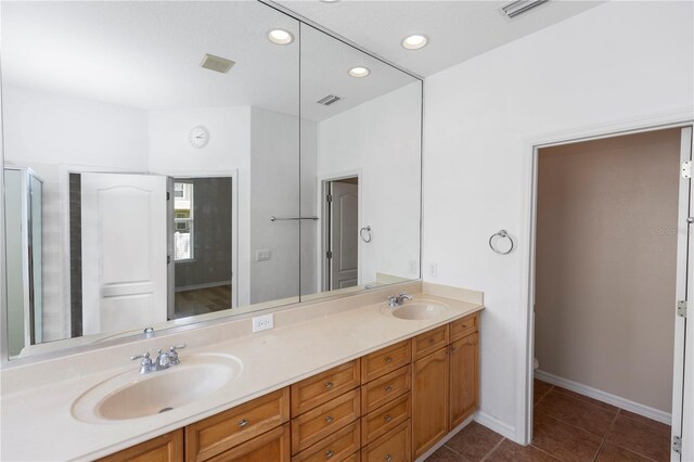 6728 Duncaster St, Windermere, FL 34786 - full bathroom with double vanity, tile patterned flooring, recessed lighting, toilet, and baseboards