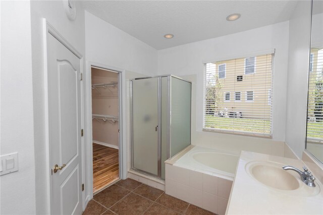 6728 Duncaster St, Windermere, FL 34786 - full bath featuring a sink, a shower stall, a garden tub, tile patterned flooring, and a walk in closet