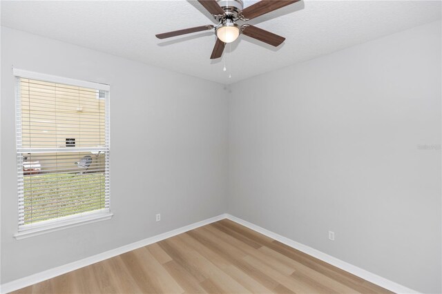 6728 Duncaster St, Windermere, FL 34786 - spare room featuring wood finished floors, baseboards, ceiling fan, and a textured ceiling