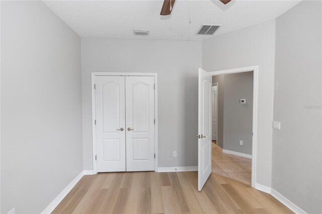 6728 Duncaster St, Windermere, FL 34786 - unfurnished bedroom with light wood-style flooring, a closet, ceiling fan, and baseboards
